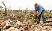 A Moore, Oklahoma resident begins cleaning debris from the wreckage of his home in the aftermath of the 2013 tornado.