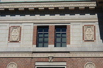 A highly decorative terra-cotta belt course between the brick and stone wall materials. Stearns-County-Courthouse-Detail1-Terra-Cotta.JPG