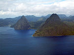 A pair of steep conical rocks rising from the sea.