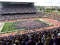 Ecstatic fans of the home team storm the field after an upset victory