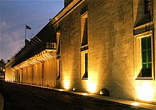 monumental stone building lit by floodlights at night