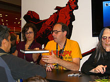 Editor Dan Braun signs collected edition of Creepy and Eerie next to a model dressed as the Creepy mascot, Uncle Creepy, at the Dark Horse Comics booth at the 2011 New York Comic Con. 10.16.11DanBraunByLuigiNovi6.jpg