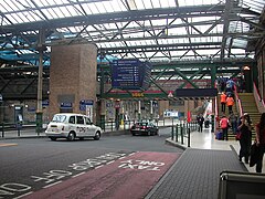 Westward view across the roadway between Platforms 7 and 11 (left) and the main concourse, with the Mezzanine Bridge visible above