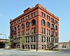 Red brick and granit building on a street corner