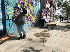 Sidewalk covered in dirt and dust, is cleaned during a street clean-up in New York, US