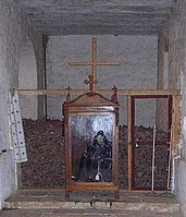 Skeleton of the monk Stephanos, in his robe, in front of the ossuary