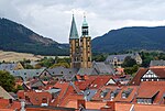 A view at a town with houses with red roofs and a church with two bell towers