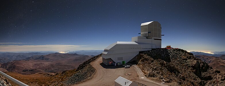 Night Light over Vera C. Rubin Observatory with the brightening of the sky due to the artificial light that can be seen as clusters of bright lights on the horizon