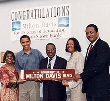 Photo of Obama and others carrying a streetsign that reads "Honorary: Milton Davis Blvd."