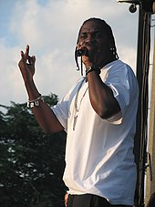 Pusha T performing with a microphone in 2007