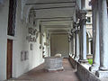 Ambulatory with stone slabs and baptismal font