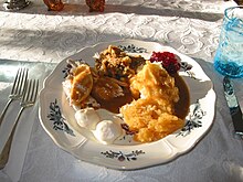 Thanksgiving dinner plate in Maine. Each region and plate has its own variations, but a sauce covered main meat with many sides is typical. Thanksgiving Dinner Alc2.jpg