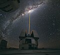 Image 5 Adaptive optics Photo: Yuri Beletsky, ESO A laser shoots towards the centre of the Milky Way from the Very Large Telescope facility in Chile, to provide a laser guide star, a reference point in the sky for the telescope's adaptive optics (AO) system. AO technology improves the performance of optical systems by reducing the effect of atmospheric distortion. AO was first envisioned by Horace W. Babcock in 1953, but did not come into common usage until advances in computer technology during the 1990s made the technique practical. More selected pictures