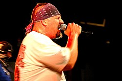 Mike Muir, the lead vocalist of the band, performing live.