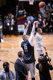 6' 11'' Nikola Jokic attempting a 3-point shot before the NBA All-Star game. Nikola Jokic (51915127158).jpg