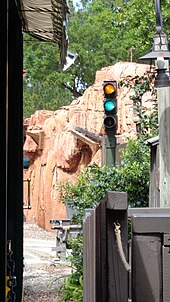 A block signal light with an artificial mountain façade behind it