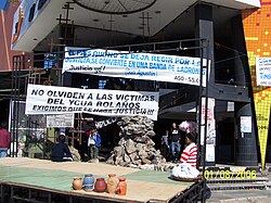 Building under renovation with banners in Spanish draping off the sides.