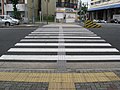 Low-profile directional tactile markings are installed on busy pedestrian crossings in Japan.