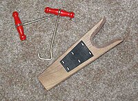 Boot hooks (left) and a boot jack (right) are sometimes needed to put on or take off some types of boots HooksAndBootjack.jpg