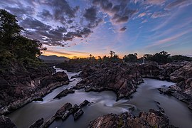 Li Phi falls at dusk with colorful sky and clouds in Don Khon Laos