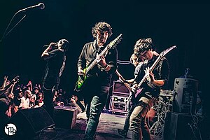 Performing in 2014 at the Skyway Theatre in Minneapolis. Depicted from left to right: Jake Wolf, Charles Caswell, Francis Xayana, Patrick Somoulay, and Cam Murray (obscured by monitors).