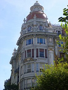 The corner of a building topped by a dome.