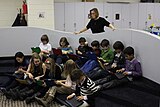 Elementary students researching in the library