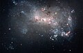 Image 14 NGC 4449 Photograph: NASA, ESA, A. Aloisi (STScI/ESA), and The Hubble Heritage (STScI/AURA)-ESA/Hubble Collaboration An image of NGC 4449, highlighting its qualities as a starburst galaxy. NGC 4449, an irregular galaxy in the constellation Canes Venatici located about 12 million light years from Earth, has a rate of star formation twice that of the Milky Way's satellite galaxy, the Large Magellanic Cloud. Interactions with nearby galaxies are thought to have influenced this star formation. More selected pictures