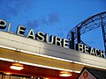 A large Pleasure Beach sign just outside the park, at night.