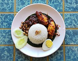 Nasi lemak: a versatile fragrant coconut rice dish served with various accompaniments, e.g. eggs (either done sunny side up or boiled), sambal sotong, rendang, ayam goreng, etc. It is the most defining feature of a Malay-style breakfast. Nasi Lemak Sambal Cumi in Indonesia 2.jpg