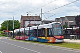 GVB 3063 in uitvoering 'Uithoornlijn' bij het eindpunt te Uithoorn. Op de achtergrond het oude Station Uithoorn; 20 juni 2024.