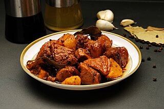 <span class="mw-page-title-main">Philippine adobo</span> Filipino dish composed of chicken/pork cooked in soy sauce and vinegar