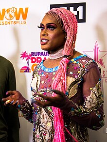 Photograph of a person wearing an outfit with many embellishments