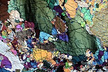 Photomicrograph of a thin section of wehrlite, in cross-polarised light Wherlite.JPG