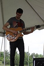 Thumbnail for File:Kevin Conner playing Harmony H70 Meteor - 2, TJ Kong and the Atomic Bomb at the Rugged Maniac 5K in Petersburg, Virginia, 2012.jpg