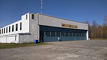 Airport hangar behind cracked pavement