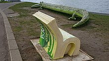 Crocodile bench and chair sculpture overlooking Cardiff Bay depicting The Enormous Crocodile The Enormous Crocodile, Cardiff Bay Barrage 20170306 140918 (48819858586).jpg