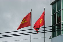 The flag of the CPV and the national flag of Vietnam flying side by side Two Flags Vietnam.JPG