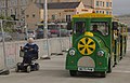 2012-08-05 A pensioner in a mobility scooter and a land train at Weston-super-Mare.