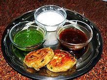 A plate of bread surrounded by sauces