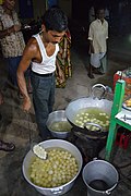 Rasgulla being taken out of the syrup