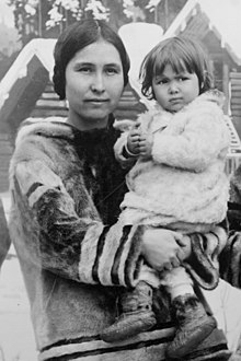 A young Inuk woman, holding a baby