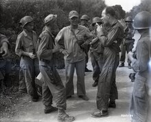 Capt Godolphin (MAG-24, USMC Air Corps) and Major Barr (USMC) who had just bombed suspected Jap positions from the air are down the front within an hour of their strike to learn from infantrymen of the 7th Cav. Regmt about accuracy of their bombing. Location: Between Manila and Anitpolo, Luzon Philippines. Unit: MAG-24 111-SC-325589.tif