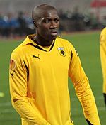 A young man wearing a yellow shirt