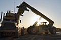 A CLB-4 handler loads a container onto an AMK31 truck at FOB Edinburgh on March 13, 2012, during retrograde operations.