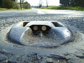 <span class="mw-page-title-main">Cat's eye (road)</span> Retroreflective safety device used in road marking