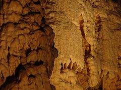 Water on calcite shimmers in the cave's lighting