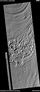 Reull Vallis floor showing lineated valley fill at the top and hollows near bottom, as seen by HiRISE under HiWish program