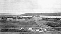 Qu'Appelle Industrial School in 1885. Parents camped outside the gate in order to visit their children. Destroyed by fire in 1904.