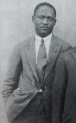 Man in a suit facing forward towards camera.